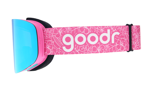 Side view of pink & blue snow goggles with blue reflective lens & pink strap with goodr logo over outlined tropical print.