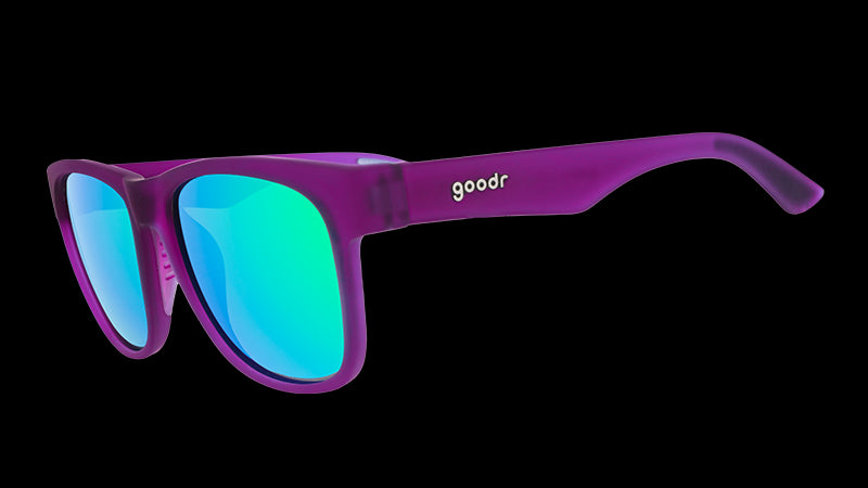 Three-quarter angle view of wide-fit purple sunglasses with square-shaped green reflective lenses.