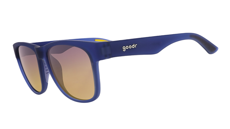 Three-quarter angle view of wide-fit navy blue sunglasses with square-shaped amber gradient lenses.