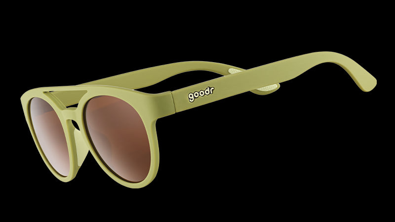 Three-quarter angle view of olive green double bridge sunglasses with non-reflective warm brown lenses.