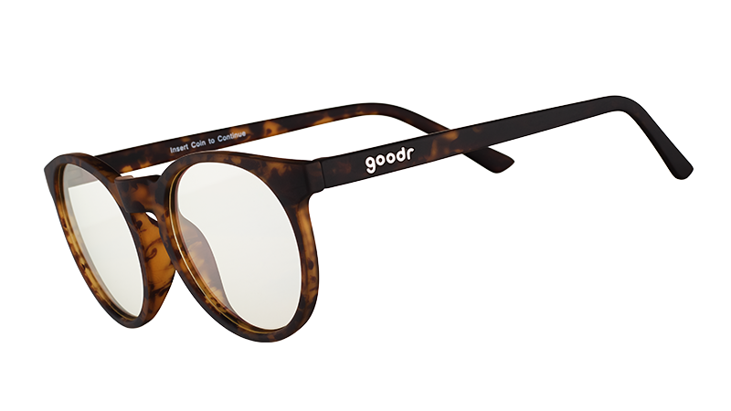 Three-quarter angle view of round brown tortoiseshell glasses with clear blue-light-blocking lenses.