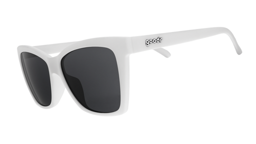 Three-quarter angle view of white angled cat-eye sunglasses with non-reflective black lenses.