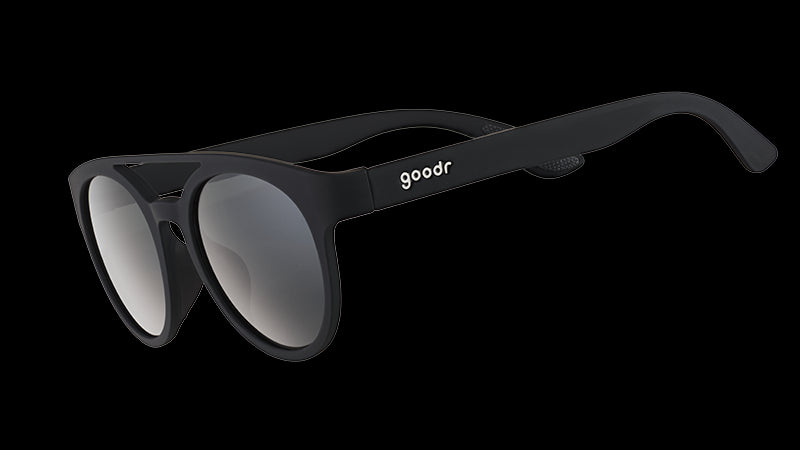 Three-quarter angle view of black round sunglasses with a double bridge and circle-shaped black non-reflective lenses.