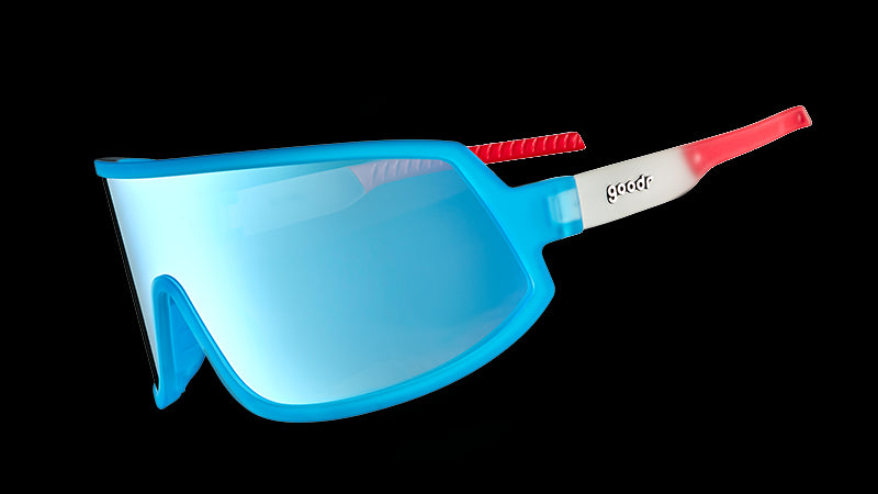 Three-quarter angle view of bright red, white, and blue wraparound sunglasses with a single blue lens.