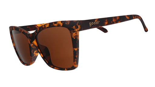 Three-quarter angle view of brown tortoiseshell angled cat-eye sunglasses with non-reflective brown lenses.