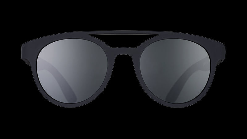 Front view of round black sunglasses with a double bridge and round black non-reflective lenses.
