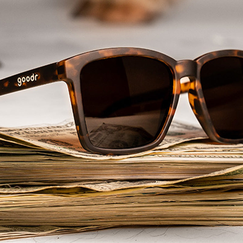 Three-quarter angle view of brown tortoiseshell sunglasses with brown non-reflective lenses.