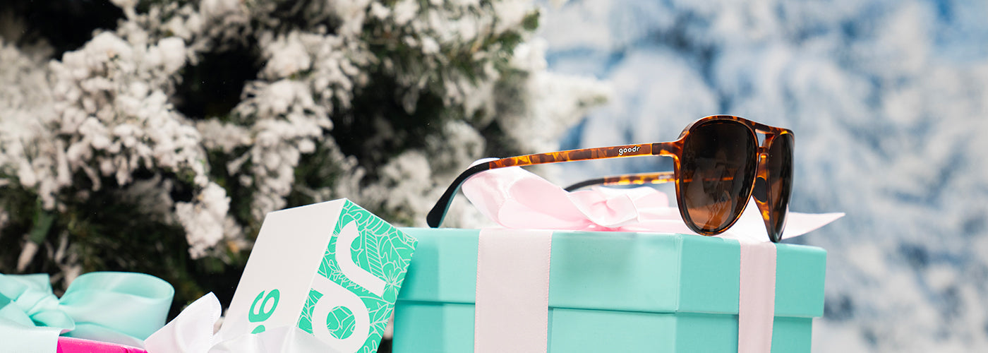 goodr sunglasses resting on a gift box outdoors.