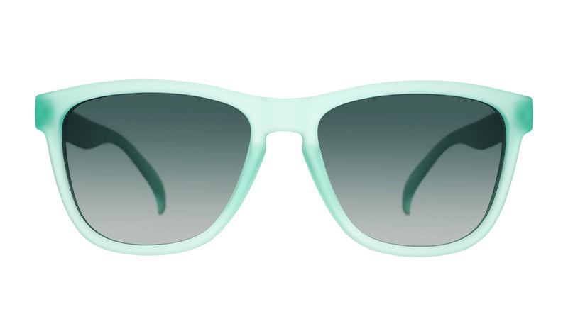 Front view of wayfarer-shaped sunglasses with translucent mint green frames and dark green gradient lenses.