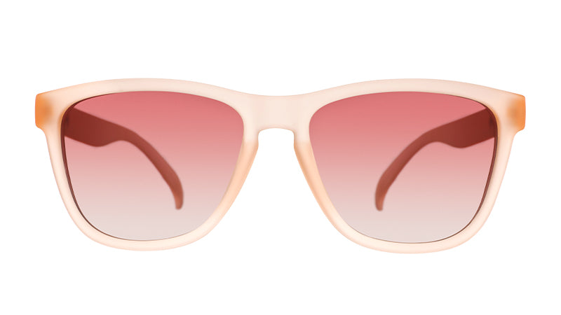 Front view of wayfarer-shaped translucent pink sunglasses with rose-tinted gradient lenses.