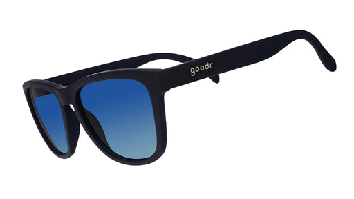 Three-quarter angle view of navy blue wayfarer-shaped sunglasses with blue gradient lenses.