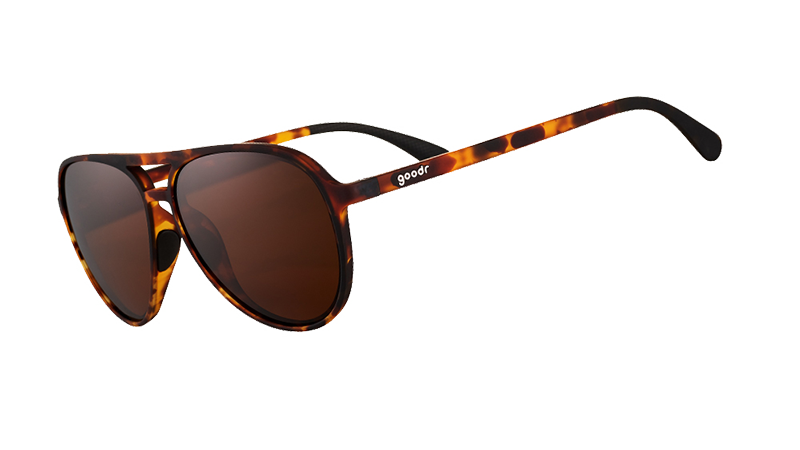 Three-quarter angle view of brown tortoiseshell aviator sunglasses with brown non-reflective lenses on a white background.