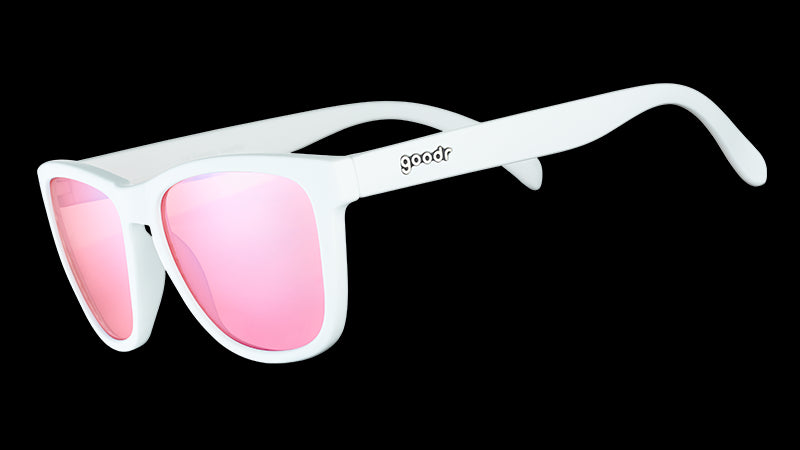 Three-quarter angle view of square-shaped white sunglasses with non-reflective rose-tinted lenses.