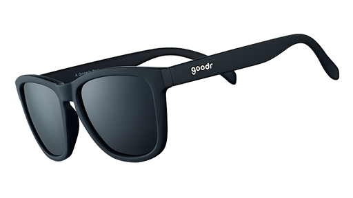 Three-quarter angle view of square-framed black sunglasses with black lenses on a white background.