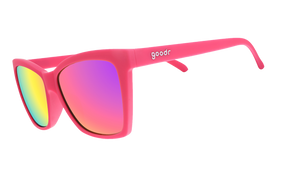 Three-quarter angle view of hot pink angled cat-eye sunglasses with pink reflective lenses.
