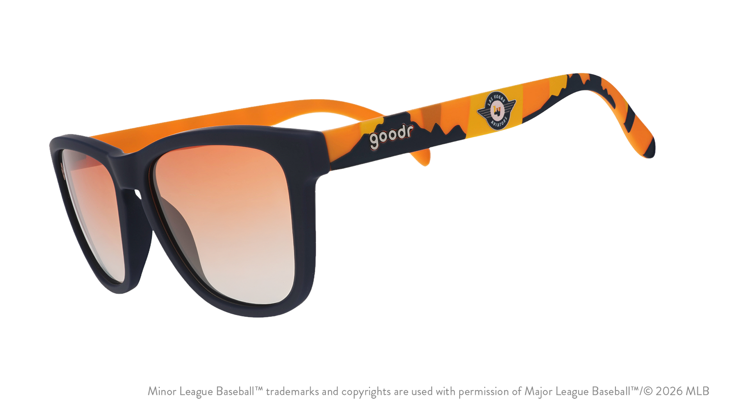 Angled view of shades tilted down. Blue frames w/ an orange+yellow landscape, Aviators logo+orange gold gradient lenses.