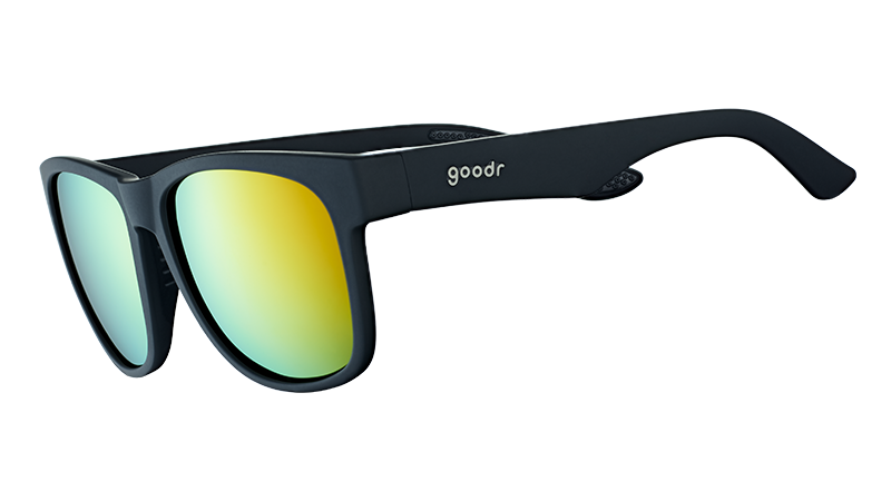 Three-quarter angle view of large square-shaped black sunglasses with mirrored amber lenses.