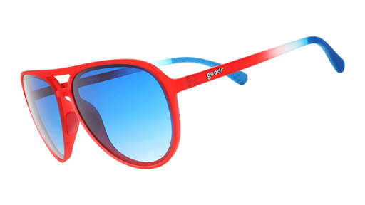 Three-quarter angle view of red, white,+blue aviator sunglasses with blue gradient lenses on a white background.