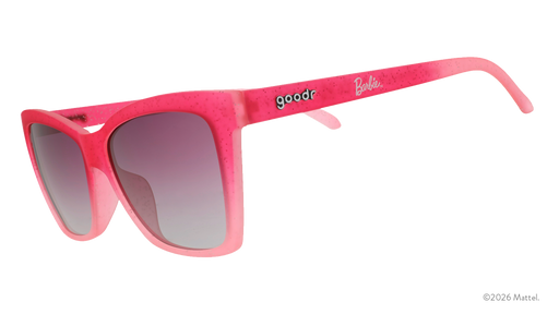 Three-quarter angle view of translucent, angular, glittery pink ombre cat-eye sunglasses with purple gradient lenses.