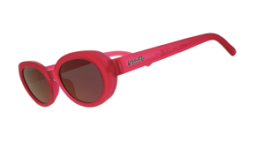 Three-quarter angle view of hot pink oval sunglasses with dark red polarized lenses against a white background.
