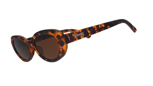 Three-quarter angle view of oval tortoiseshell sunglasses with brown polarized lenses against a white background.