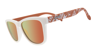 The image displays a pair of sunglasses with a white front frame and orange reflective lenses. The arms of the sunglasses are orange and decorated with University of Texas Longhorns logos