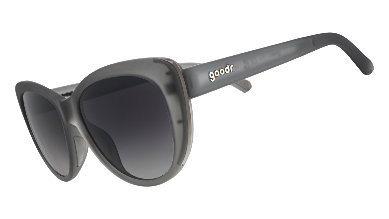 Three-quarter angle view of translucent gray cat-eye sunglasses with black gradient lenses.