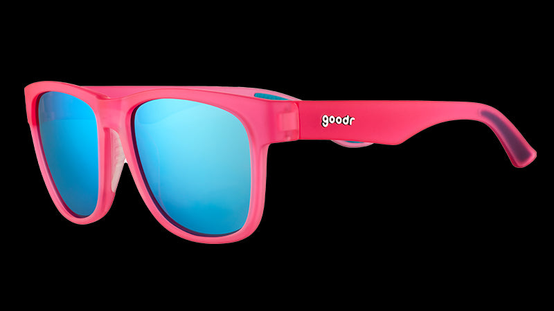 Three-quarter angle view of square-shaped, wide-fit pink sunglasses with blue reflective lenses.