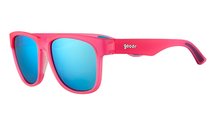 Three-quarter angle view of square-shaped, wide-fit pink sunglasses with blue reflective lenses.