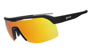 Sunglasses with black frame and orange-tinted lenses on a white background