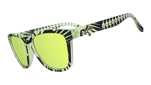 Three-quarter angle view of black frames with a green glow-in-the-dark skeletal design and green reflective lenses.