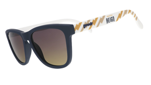 Three-quarter view of black and white sunglasses with a golden sunrise pattern, the Seattle Reign logo, and gray-to-yellow ocean gradient lenses.