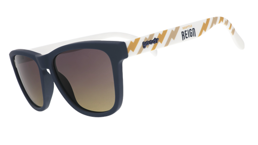 Three-quarter view of black and white sunglasses with a golden sunrise pattern, the Seattle Reign logo, and gray-to-yellow ocean gradient lenses.