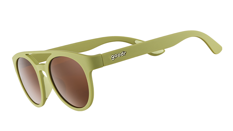 Three-quarter angle view of olive green double bridge sunglasses with non-reflective warm brown lenses.