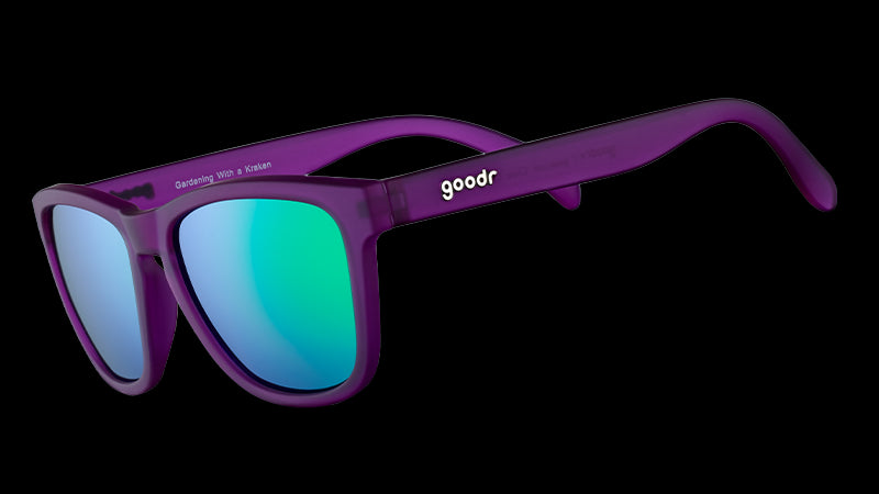 Three-quarter angle view of square-shaped sunglasses with purple frames and reflective green polarized lenses.