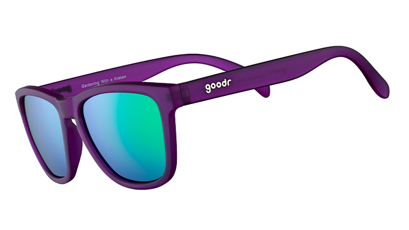 Three-quarter angle view of square-shaped sunglasses with purple frames and reflective green polarized lenses.