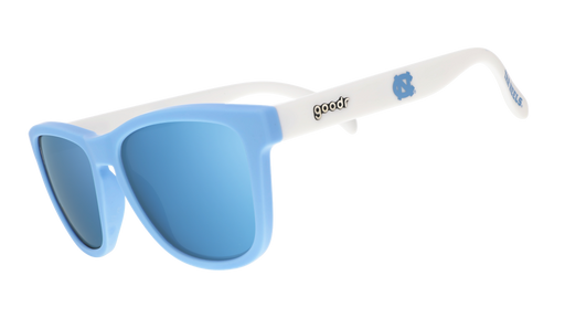 Three-quarter angle view of Carolina blue and white sunglasses featuring ice blue reflective lenses and the UNC logo.