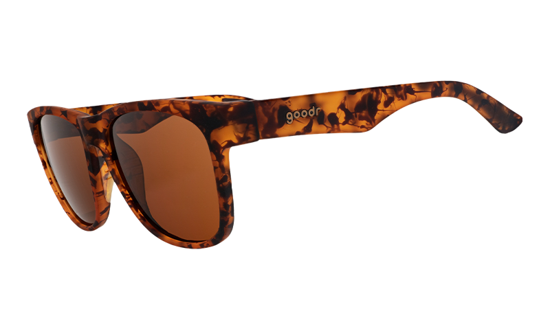 Three-quarter angle view of square-shaped, wide-fit tortoiseshell sunglasses with brown non-reflective lenses.
