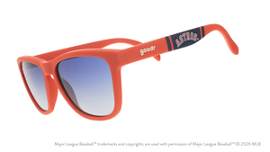 Three-quarter angle view of orange and navy Astros sunglasses featuring an Astros logo on the arm.