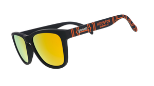 Three-quarter angle view of MLS Houston Dynamo FC shades tilted down. Black+orange frames. Amber reflective lenses.