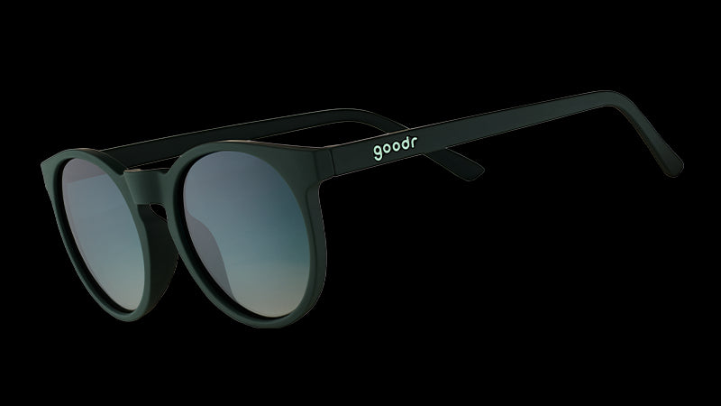 Three-quarter angle view of dark green round sunglasses with circle-shaped green gradient lenses.