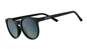 Three-quarter angle view of dark green round sunglasses with circle-shaped green gradient lenses.