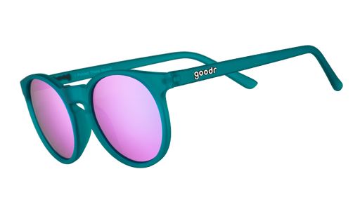 Three-quarter angle view of round teal sunglasses with reflective purple circle-shaped lenses.
