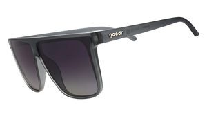 Three-quarter angle view of translucent gray, flat-top Fly G sunglasses with gray gradient lenses.