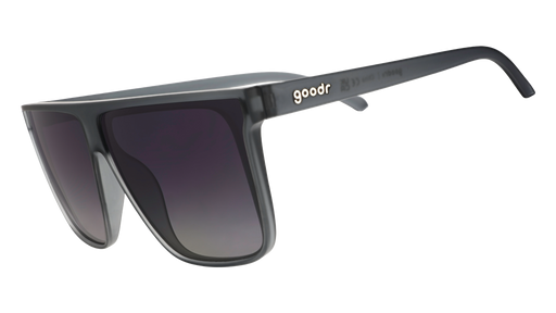 Three-quarter angle view of translucent gray, flat-top Fly G sunglasses with gray gradient lenses.