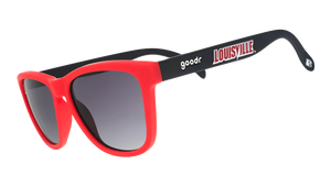 Three-quarter angle view of black and Cardinal red sunglasses featuring black gradient lenses and a Louisville logo.