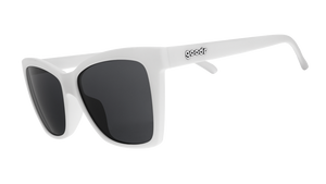 Three-quarter angle view of white angled cat-eye sunglasses with non-reflective black lenses.