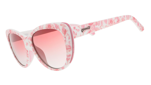 Three-quarter angle view of pink and white cat-eye sunglasses with a floral toile pattern and rose gradient lenses.