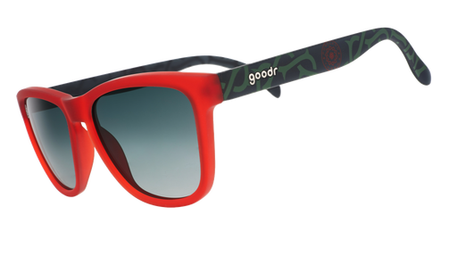 Three-quarter angle view of red and black frames with a green thorn pattern, green gradient lenses, and the Portland Thorns logo.