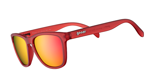 Three-quarter angle view of square-shaped sunglasses with red translucent frames and red reflective lenses.